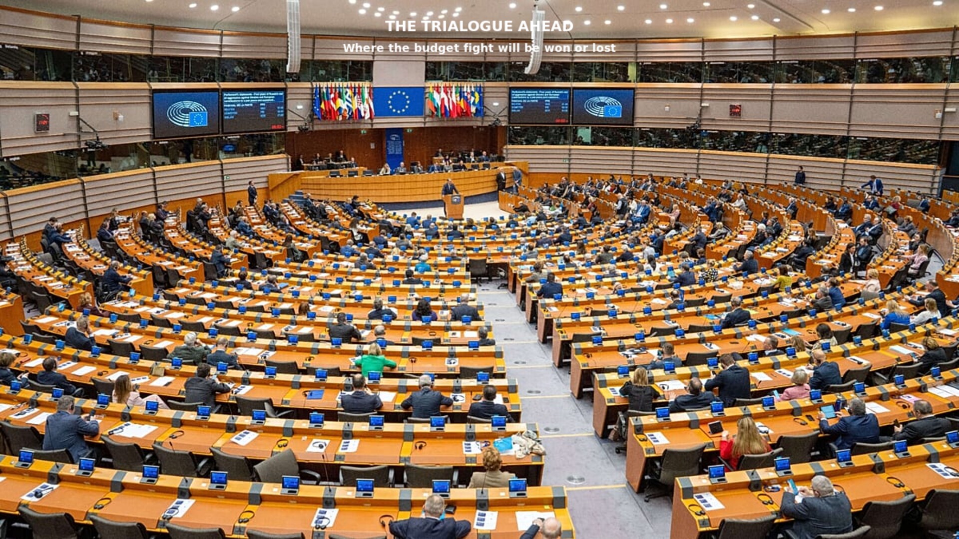European Parliament during a vote, MEPs raising hands in a plenary session